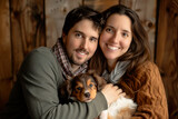 Fototapeta Nowy Jork - Millennial couple portrait holding their puppy. New family choices concept