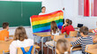 © JackF - Positive female teacher explaining lgbt theme to children during lesson in class in secondary school