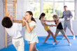 © JackF - Children in sparring improve skill of performing strangulation and neutralizing enemy during krav maga class. Pupils strike out at mandible and body at self-defense lesson
