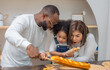 © SpaceOak - Multiracial Family Spending Quality Time Together Baking Bread in a Cozy Kitchen Setting