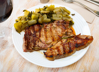 Wall Mural - Barbecue veal steak served with marinated chopped chard leaves