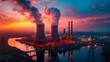 A power plant with two large smokestacks is lit up at sunset