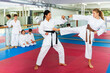 © JackF - Young girl fighting with her karate teacher during group karate training. Other kids watching their moves.