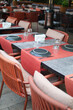 A city restaurant with orange and black outdoor furniture