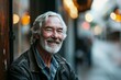 © Inigo - Portrait of a senior man with gray hair and beard in a leather jacket on a city street