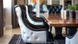 Chic black and white chair with a cushioned seat in front of a table. Stylish and versatile seating option for any space