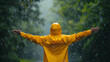 Person embracing the rain with open arms and a spirit of freedom, captured in a vibrant yellow raincoat - Image made using Generative AI