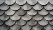 A series of grey, rounded tiles that resemble the scales of a dragon