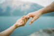 Hand Embrace Against Mountain Backdrop