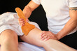 Legs of a woman on maderotherapy anticellulite massage treatment at beauty spa salon.