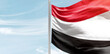 Yemen national flag with mast at light blue sky.