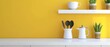 Various kitchen utensils on a white table with a yellow wall. 3D rendering.
