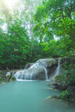 Fototapeta Zachód słońca - Beautiful deep forest waterfall in Thailand