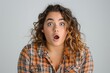 © Luismartin_fit - Young woman in plaid shirt showing surprise expression