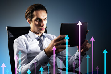 Canvas Print - Attractive young european businessman using tablet with various growing arrows on gray background. Growth, future and performance concept.