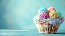 Basket Full Of Assorted Colorful Yarn Balls On A Turquoise Wooden Background.