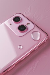 Poster - Close-up of a cell phone on a pink surface, suitable for technology concepts