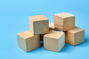 Poster - A pile of wooden blocks on a blue surface. Great for educational concepts