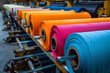 Colorful rolls of fabric in textile factory