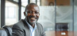 © AI_images - A cheerful African businessman smiles warmly in the office boardroom, exuding positivity and confidence.