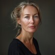 © Minerva Studio - Close-up of a poised woman with subtle smile on a warm, neutral background