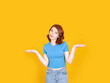 I have no idea, portrait of young caucasian red bob hair woman shrugging shoulders say I have no idea. Confused girl don't know answer. Standing over yellow studio background, isolated, copy space.