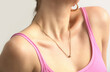 Cleavage of women with beautiful gold necklace, beautiful neck and neckline, clean skin, studio shot.