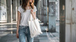 A woman carrying white blank tote bag with no design mockup