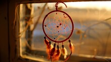 A Red Dream Catcher Is Hanging From A Window