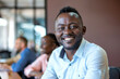 © AI_images - Smiling brightly, an African businessman brings positive energy to the office boardroom, inspiring his colleagues with his optimism and warmth.