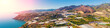Panoramic view of the sea of greenhouses. Greenhouses in the south of Spain near Maro city, Nerja, Malaga, Spain. View from a drone. Horizontal banner