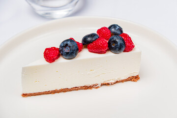 Wall Mural - cheesecake with berries on the white