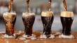 Four stages of a pint of stout from the moment it is poured till it is ready to drink.