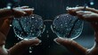 Water drops glow like crystals on the dark background of a glasses. A woman holds the glass with raindrops on it.