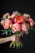 © dashtik - The delicate hands of a woman cradle an opulent bouquet of peonies