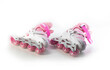 Pink girlish roller skates on a white background, isolate. Close-up