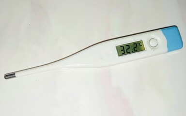 Electronic body thermometer that displays a healthy human body temperature of 32.2 degrees C (Celsius). Isolated on white background.