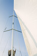 White sail genoa in the wind on the sailboat, blue sky background, windy day
