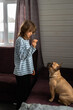 Girl playing with little dog, feeding french bulldog
