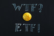 Bitcoin and ETF inscription in chalk close-up on a black background.