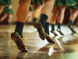 Several dancers perform a traditional Irish dance in honor of St. Patrick's Day. The emphasis is on the dancers' feet 