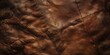 Detailed close up of dark brown leather showcasing its natural texture and patterns resembling luxury and craftsmanship