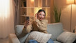 © golubovy - Mobile selfie. Happy woman. Home leisure. Smiling relaxed female taking care hairstyle looking smartphone sitting light room interior.