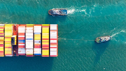 Canvas Print - Top view Container ship full capacity approaching the port by a tugboat occupying the port International Container ship loading, unloading at sea port, Freight Transportation, Shipping,  Vessel.