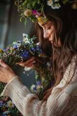 Wall Mural - a woman makes a wreath of flowers in the field