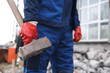 Man in uniform with sledgehammer outdoors, closeup