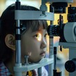 Realistic little girl Asian undergoing an eye test at an ophthalmologist
