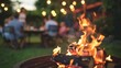Blurry background of a backyard barbecue with families gathered around a cozy bonfire and enjoying each others company in the warm glow. .