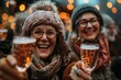 Close-up of two joyous women celebrating with beer glasses against a bokeh light backdrop