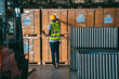 © chokniti - African American person working to shipping box package by order in logistic warehouse, black male work in delivery distribution job service in storage factory, man checking good of industry business